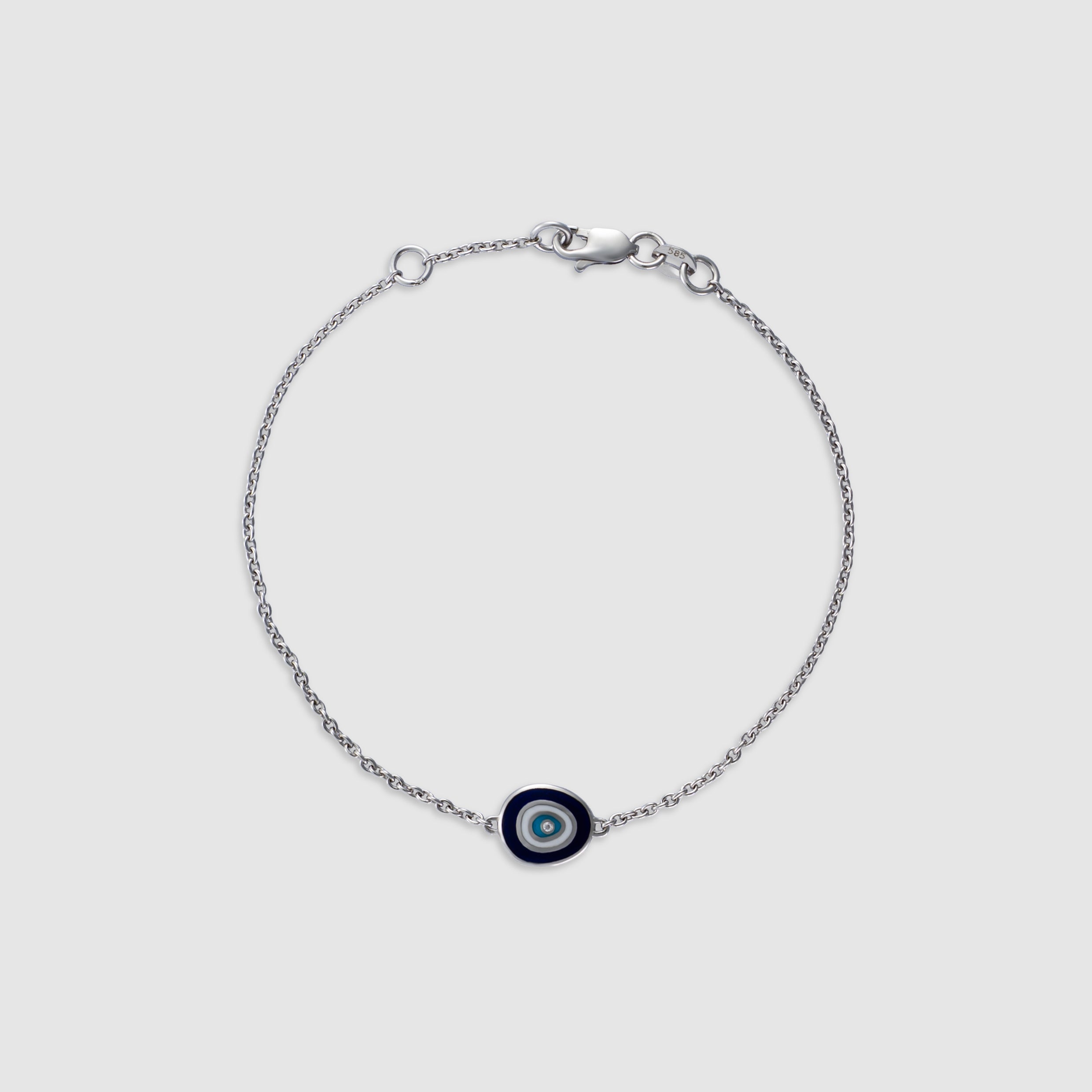 14K white gold bracelet with a diamond evil eye charm