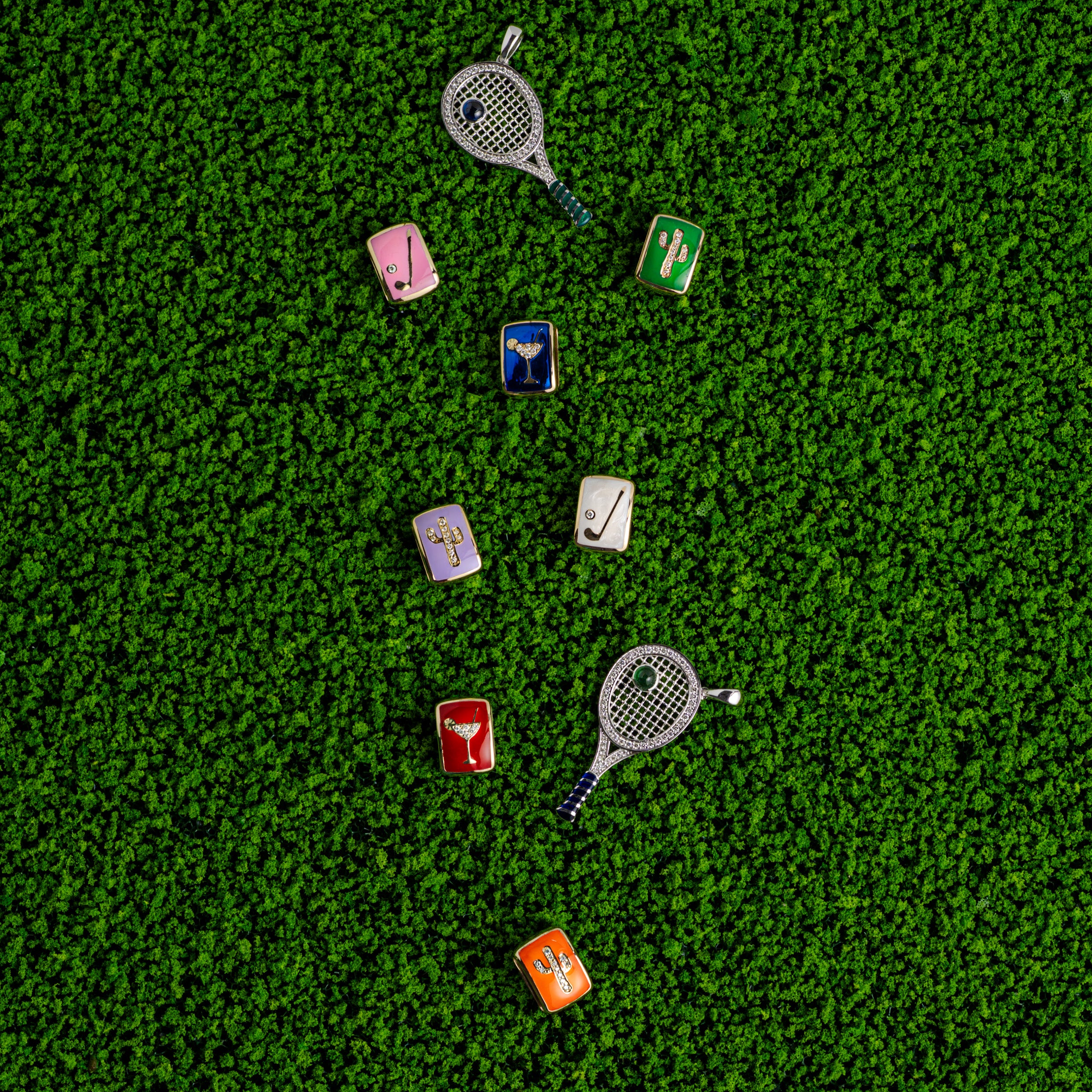 Collection of diamond charms on a green grass