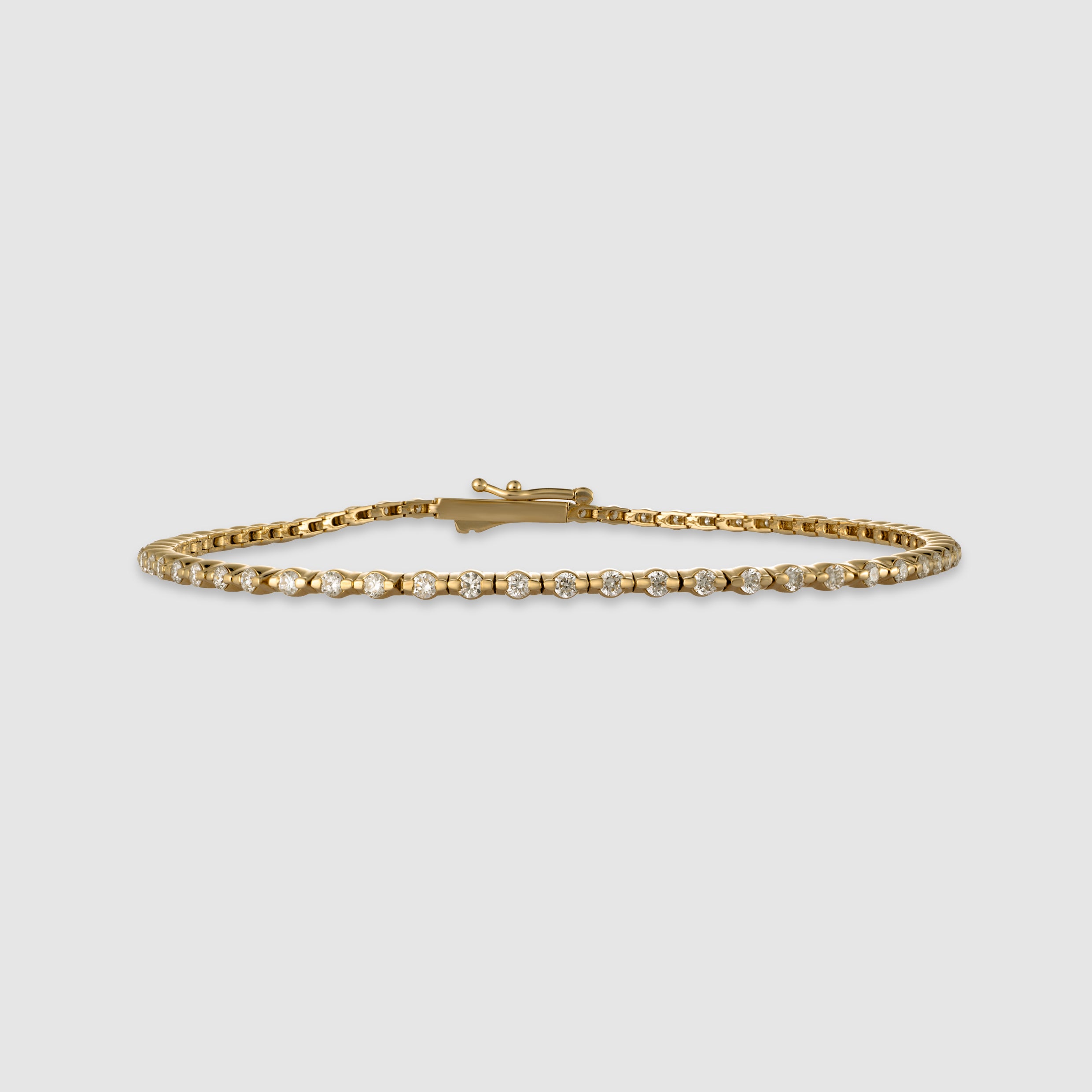14K yellow gold round-cut diamond tennis bracelet in a bezel setting