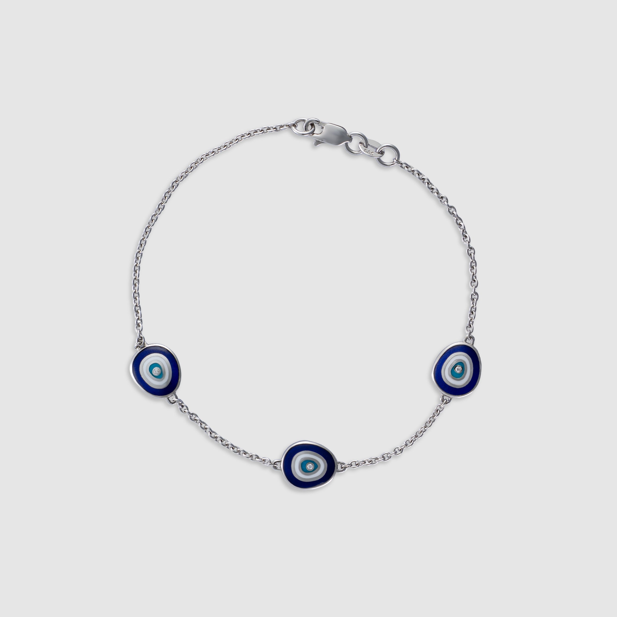 14K white gold bracelet with diamond evil eye charms