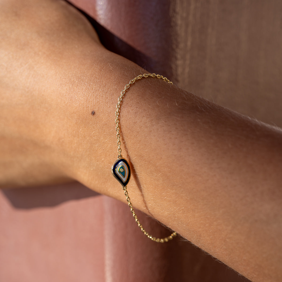 a woman wearing a teardrop shape evil eye diamond bracelet